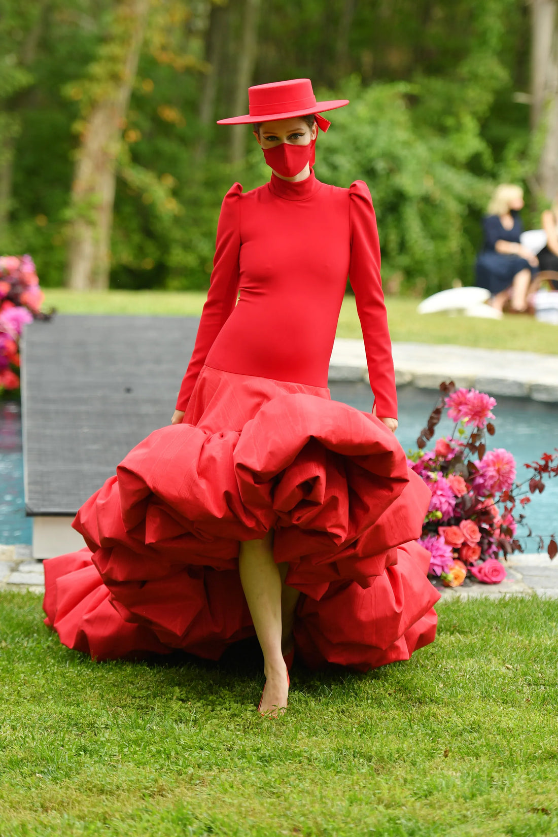 Coco Rocha wearing red dress at Christian Siriano’s fashion show